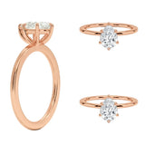 Detailed side view of a pear shaped moissanite ring showing the protective V-prong and slim gold band.