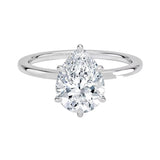Close-up of a high-quality D-color VVS1 pear cut moissanite in a simple and elegant gold setting.