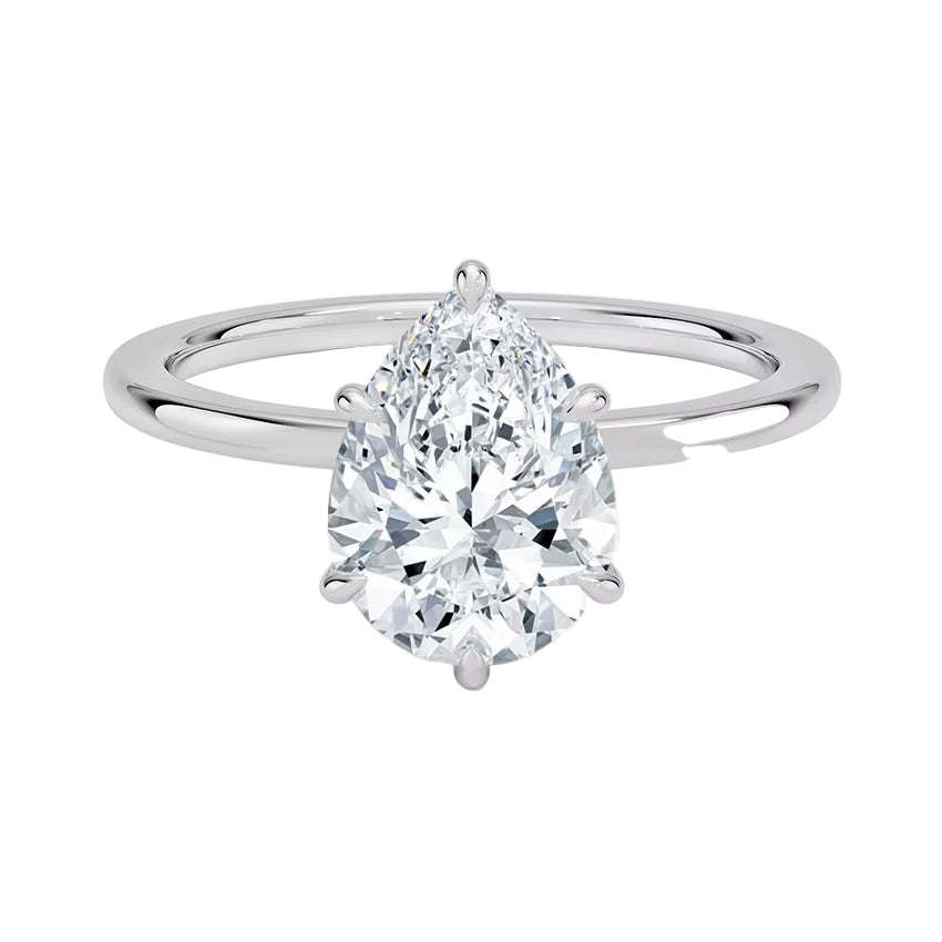 Close-up of a high-quality D-color VVS1 pear cut moissanite in a simple and elegant gold setting.