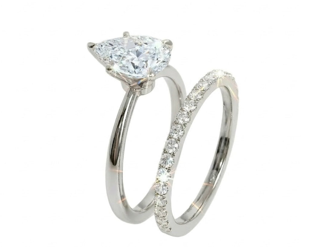 Detailed side view of the Pear Duo Grace set showing the flush-fit between the solitaire and eternity band.