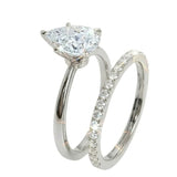 Detailed side view of the Pear Duo Grace set showing the flush-fit between the solitaire and eternity band.