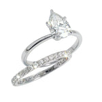 Close-up of a D-color VVS1 pear-cut moissanite demonstrating high-clarity facets and teardrop shape.