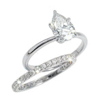 Close-up of a D-color VVS1 pear-cut moissanite demonstrating high-clarity facets and teardrop shape.