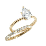 Close-up of a D-color VVS1 pear-cut moissanite demonstrating high-clarity facets and teardrop shape.