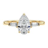Luxury pear cut moissanite engagement ring in yellow gold with structural tapered baguette side stones ApolloGem South Africa.