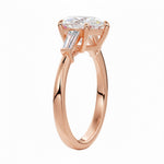 Classic three-stone pear moissanite engagement ring a showing the timeless brilliance and flattering teardrop shape.