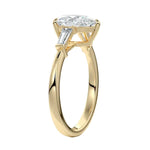Detailed side view of a high-set pear moissanite ring showing the secure V-prong setting and structural baguette accents.