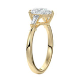 Detailed side view of a high-set pear moissanite ring showing the secure V-prong setting and structural baguette accents.