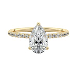 Dainty three-claw pear cut moissanite ring with a half eternity pavé band in yellow gold