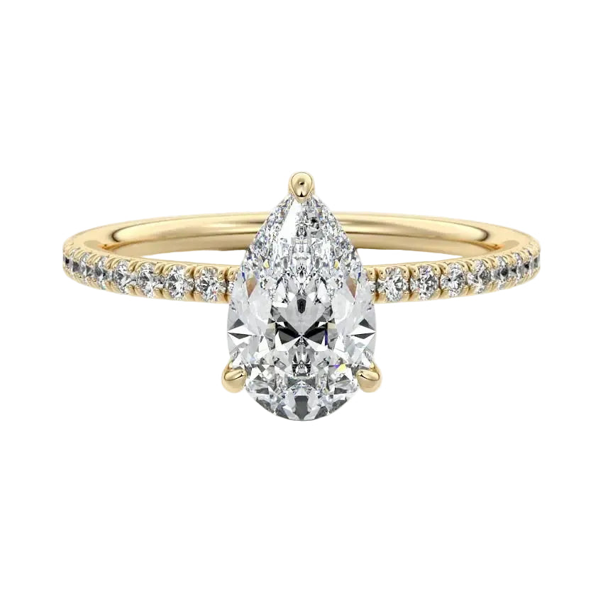 Dainty three-claw pear cut moissanite ring with a half eternity pavé band in yellow gold