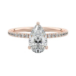 Dainty three-claw pear cut moissanite ring with a half eternity pavé band in rose gold