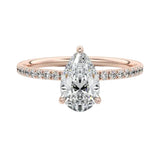 Dainty three-claw pear cut moissanite ring with a half eternity pavé band in rose gold