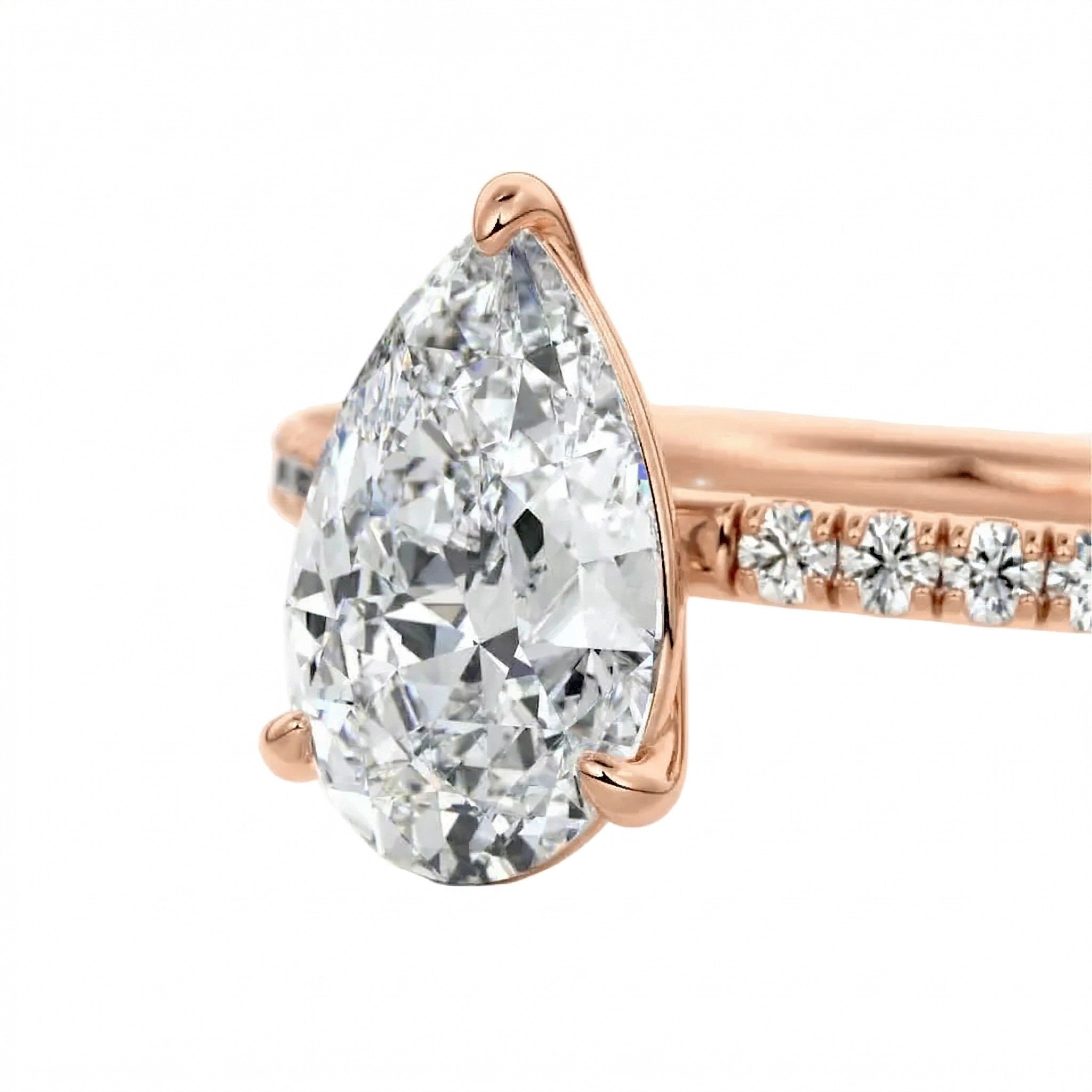 Top-down view of a D-color VVS1 pear brilliant moissanite in a rose gold solitaire setting.