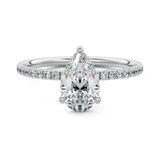 Dainty three-claw pear cut moissanite ring with a half eternity pavé band in white gold