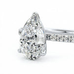 Top-down view of a D-color VVS1 pear brilliant moissanite in a white gold solitaire setting.