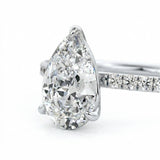 Top-down view of a D-color VVS1 pear brilliant moissanite in a white gold solitaire setting.