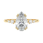 Minimalist pear cut moissanite engagement ring in yellow gold with four graduated round side stones ApolloGem South Africa.