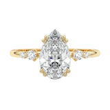 Minimalist pear cut moissanite engagement ring in yellow gold with four graduated round side stones ApolloGem South Africa.