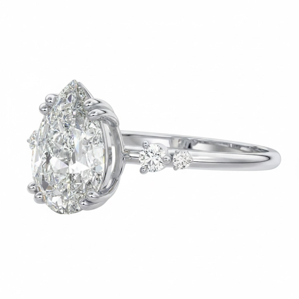 Modern bridal stack with a pear cut three-stone style moissanite ring and a thin gold band for a minimalist luxury look.