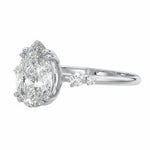 Modern bridal stack with a pear cut three-stone style moissanite ring and a thin gold band for a minimalist luxury look.