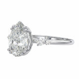 Modern bridal stack with a pear cut three-stone style moissanite ring and a thin gold band for a minimalist luxury look.