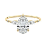 Pear cut moissanite engagement ring yellow gold marquise side stones botanical design