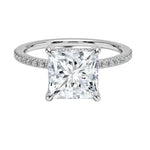 Secure four-claw princess cut moissanite ring with a uniform pavé-set white gold band ApolloGem.