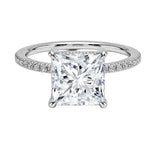 Secure four-claw princess cut moissanite ring with a uniform pavé-set white gold band ApolloGem.
