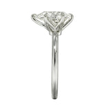 Diamond ring with a heart-shaped center stone on a white background