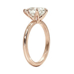 High-resolution jewelry render of a pear moissanite solitaire with a polished rose gold shank.