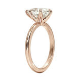 High-resolution jewelry render of a pear moissanite solitaire with a polished rose gold shank.