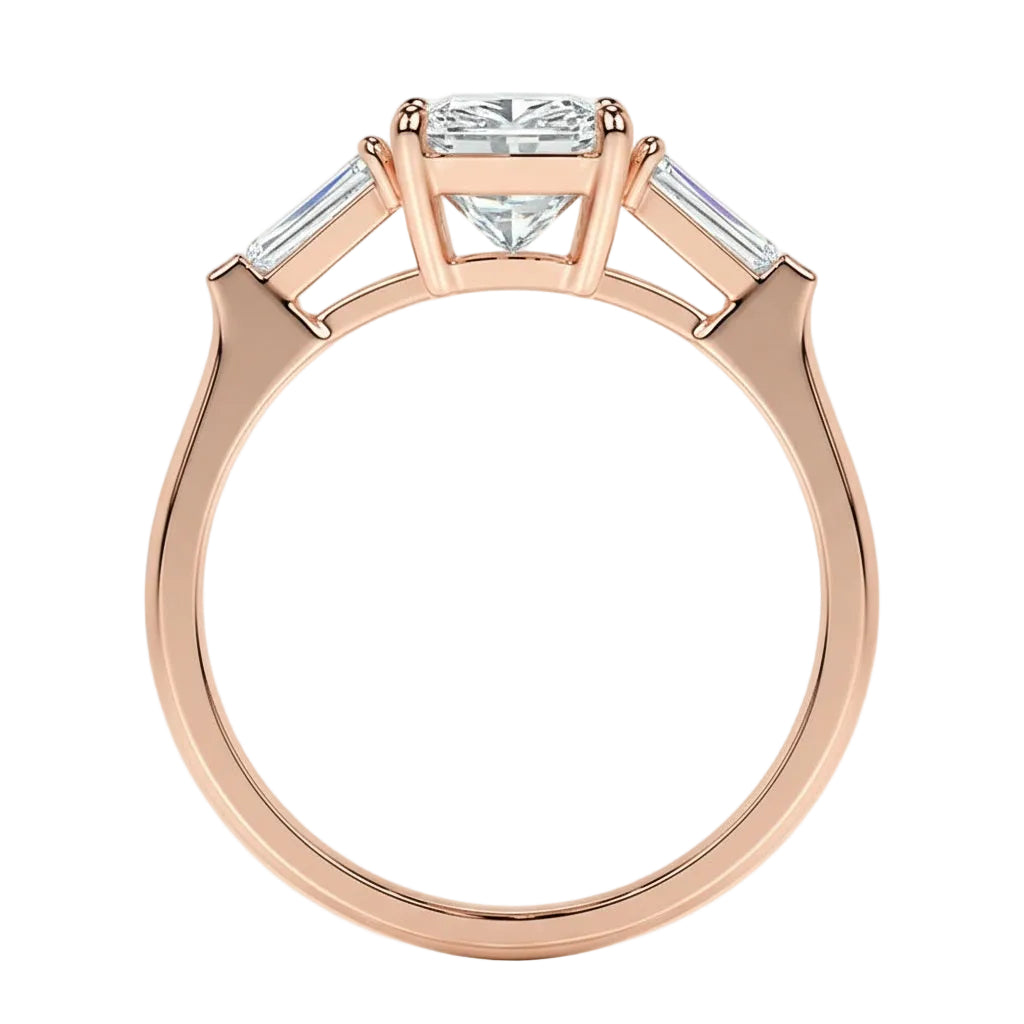 Rose gold ring with a central diamond flanked by two smaller diamonds on a white background