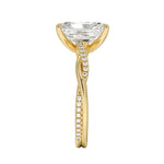 Top-down view of a D-color VVS1 radiant stone in a yellow gold infinity twist setting.