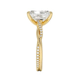 Top-down view of a D-color VVS1 radiant stone in a yellow gold infinity twist setting.