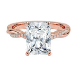 Four-claw radiant cut moissanite engagement ring with a pavé infinity twist vine band in rose gold ApolloGem.