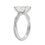 Side profile of the Radiant Infinity Twist ring showing the interlocking smooth and pavé-set gold bands.