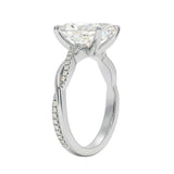 Side profile of the Radiant Infinity Twist ring showing the interlocking smooth and pavé-set gold bands.