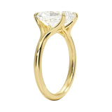 Detailed side view of a radiant moissanite ring showing the architectural split-shoulder design and cat-claw setting.