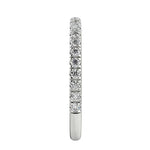 Top-down view of a D-color VVS1 3/4 circle round moissanite wedding band in white gold.