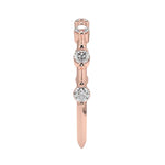 Top-down view of a D-color VVS1 2.0mm round stone bezel-set band in rose gold.