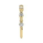 Top-down view of a D-color VVS1 2.0mm round stone bezel-set band in yellow gold.