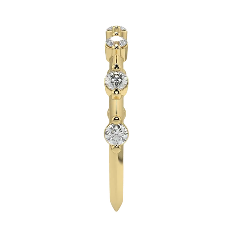 Top-down view of a D-color VVS1 2.0mm round stone bezel-set band in yellow gold.