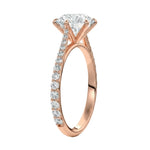 Top-down view of a D-color VVS1 round stone in a rose gold six-prong cathedral setting.