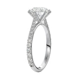 Top-down view of a D-color VVS1 round stone in a white gold six-prong cathedral setting.