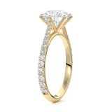  Top-down view of a D-color VVS1 round stone in a yellow gold six-prong cathedral setting.
