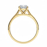 Symmetrical top-down view of a round moissanite solitaire in a polished yellow gold cathedral setting.