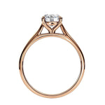 Symmetrical top-down view of a round moissanite solitaire in a polished yellow gold cathedral setting.