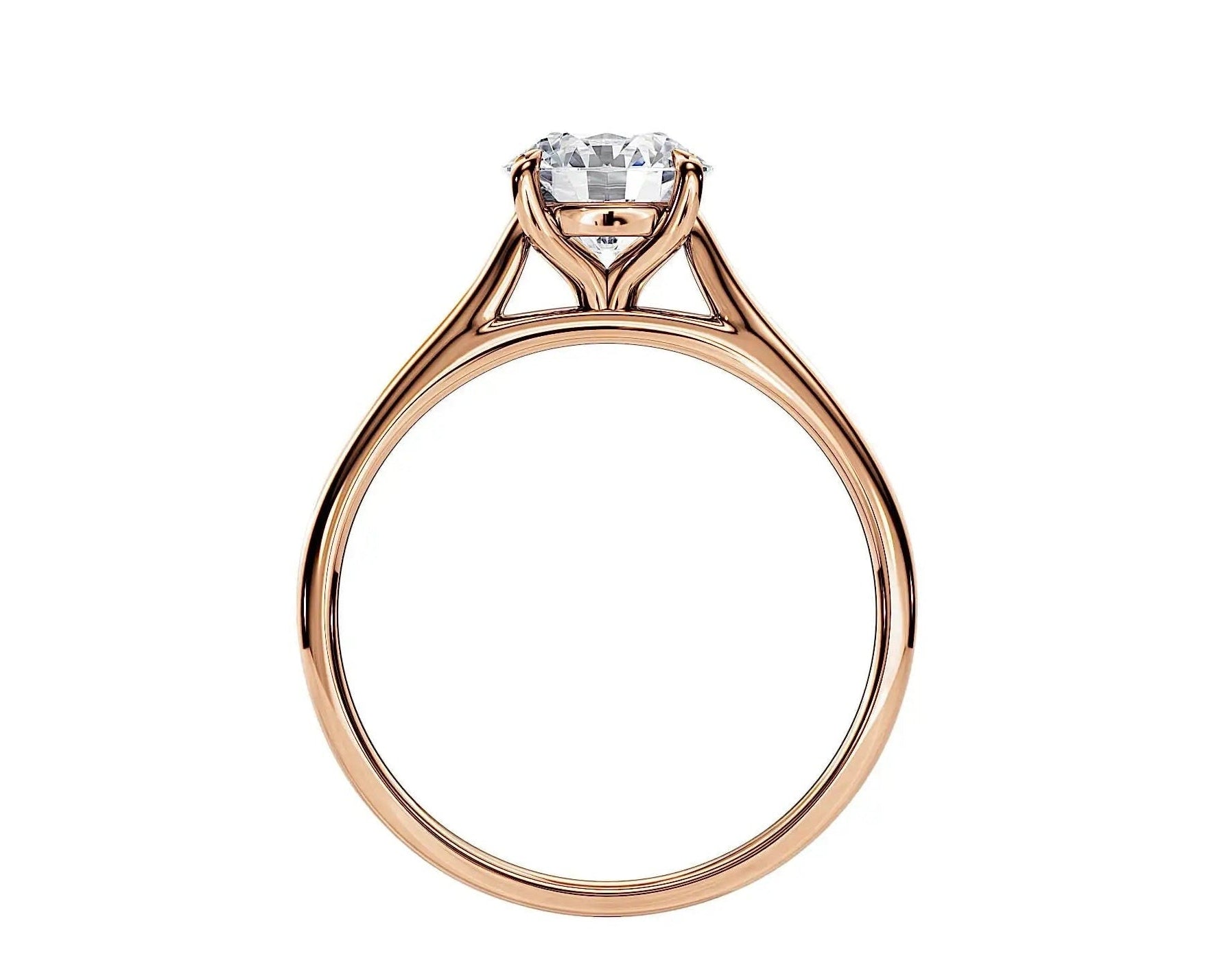 Symmetrical top-down view of a round moissanite solitaire in a polished yellow gold cathedral setting.