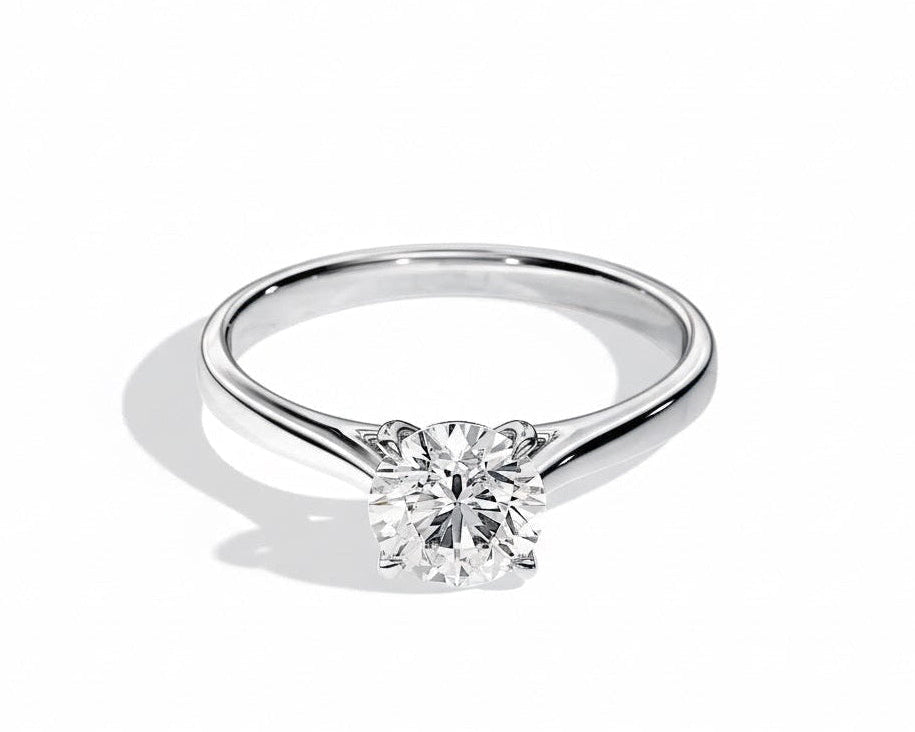 Close-up of a D-color VVS1 round moissanite held by elegant, sophisticated cathedral prongs.