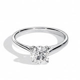 Close-up of a D-color VVS1 round moissanite held by elegant, sophisticated cathedral prongs.